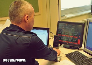 Dyżurny Policji podczas pracy przed monitorem