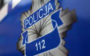 Policyjna odznaka i napis Policja