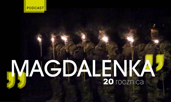 Policjanci BOA stojący w szeregu z uniesionymi płonącymi pochodniami.