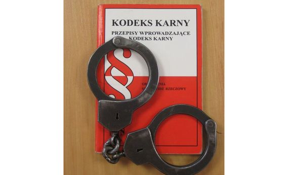 Kodeks karny i leżące na nim kajdanki