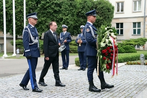 Minister Spraw Wewnętrznych i Administracji Mariusz Kamiński i Komendant Główny Policji gen. insp. Jarosław Szymczyk w asyście policjanta składają wieniec przed obeliskiem