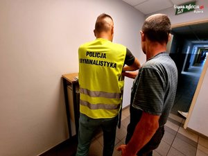 pobieranie odcisków palców zatrzymanego mężczyzny