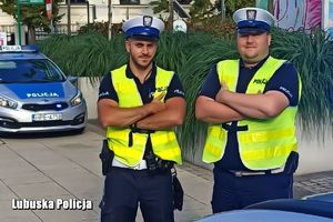dwóch umundurowanych policjantów w kamizelkach odblaskowych