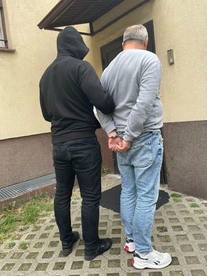 policjant z zatrzymanym mężczyzną