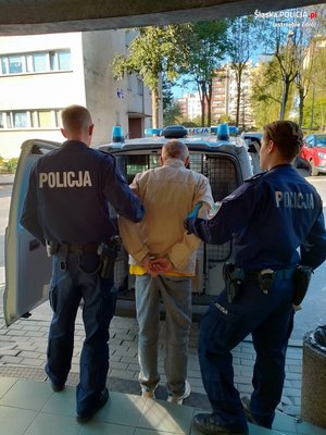 dwaj policjanci prowadzą zatrzymanego