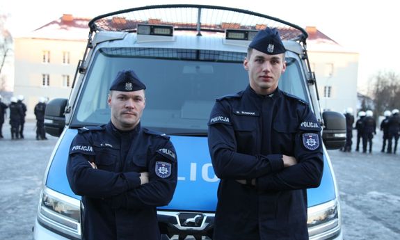 Dwóch policjantów przy radiowozie