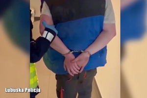 Na zdjęciu zatrzymany mężczyzna w kajdankach na rękach