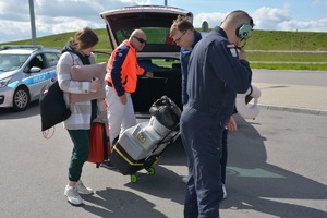 radiowóz, specjalistyczny sprzęt. dookoła kilka osób