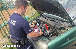 policjant pomaga odpalić samochód