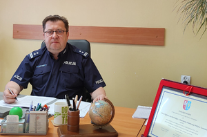 policjant siedzi przy biurku