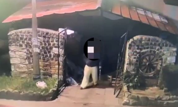podpalacz wychodzi z altany po podpaleniu