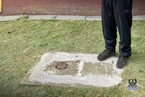 mężczyzna stoi na betonowej studzience