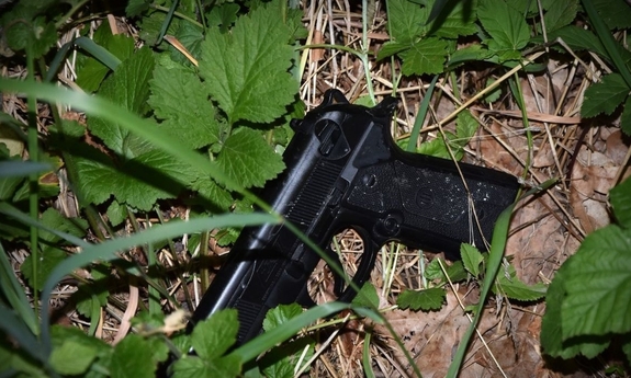 na zdjęciu zabezpieczona broń leżąca w krzakach