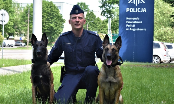 Policjant Adrian Ziarko w towarzystwie dwóch psów policyjnych
