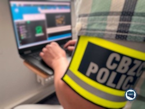 na zdjęciu funkcjonariusz CBZC pisze na klawiaturze laptopa