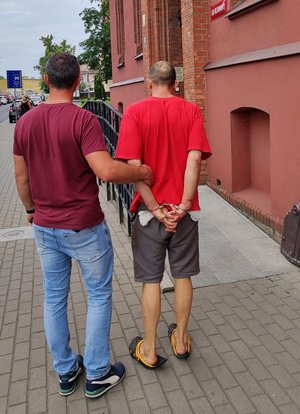 Policjant prowadzi zatrzymanego