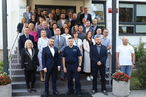 uczestnicy szkolenia stoją na schodach pozując do zdjęcia grupowego