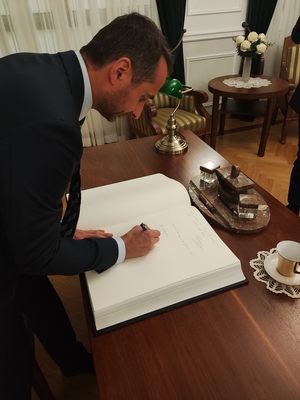 Przedstawiciel Policji z Dubaju wpisuje się do księgi pamiątkowej.