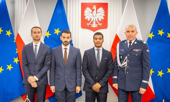 I zastępca komendanta głównego Policji z przedstawicielami Policji z Dubaju. W tle flagi Polski i Unii Europejskiej.