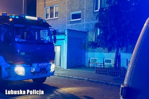 Wóz straży pożarnej przed budynkiem.