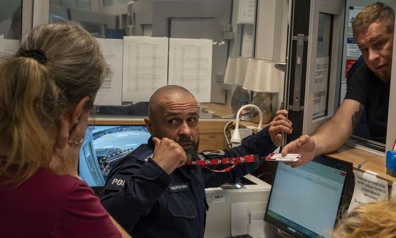rejestracja w przychodni. policjant pokazuje pielęgniarce jak się bronić przed napastnikiem.