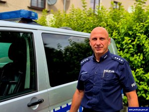 Policjant przy radiowozie.