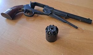 zabezpieczony rewolwer leży na biurku.