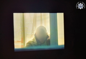 Mężczyzna wygląda przez okno.