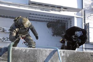 Funkcjonariusze BOA i alpiniści schodzą na linach z dachu szpitala.