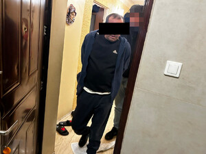 Zatrzymany mężczyzna na pierwszym planie, z tyłu widać policjanta.