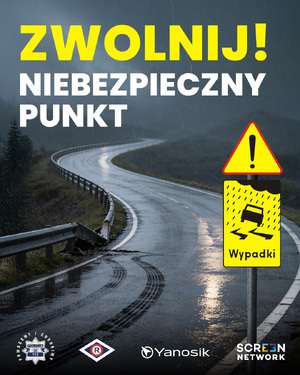 Plakat informacyjny z napisem: Zwolnij! Niebezpieczny punkt. W tle kręta droga.