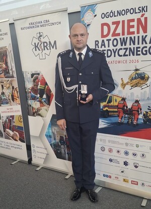 Policjant z odznaką Krzyża Zasługi.
