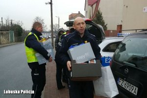 policjanci niosą paczki