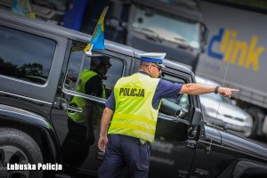 policjant wskazuje drogę kierowcy