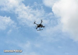 Latający dron na tle nieba.