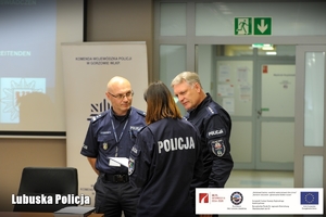 Policjanci i policjantka omawiają rozpoczęcie konferencji