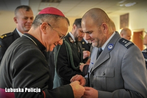 Policjant składa życzenia świąteczne biskupowi