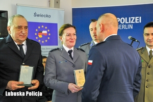 Policjant wręcza nagrody wyróżnionym