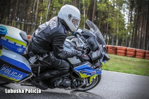 policjant na motocyklu jedzie po torze