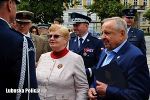 Policjant odbiera gratulacje od parlamentarzystów.