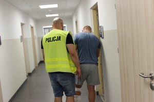 Policjant prowadzi sprawcę wypadku śmiertelnego