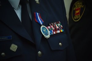 odznaczenie wiszące na klapie munduru policyjnego