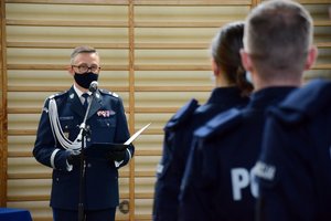 Sala gimnastyczna Oddziału Prewencji Policji w Łodzi. uroczystość ślubowania policjantów. Komendant czyta rotę ślubowania.