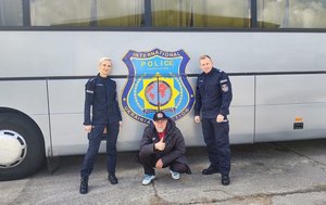 Policjanci stoją przed autobusem.