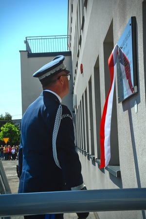 Komendant Wojewódzki Policji w Łodzi przed pamiątkową tablicą.