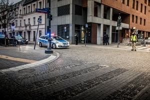 policjanci zabezpieczają szczyt OBWE, kolumna pojazdów uprzywilejowanych wjeżdża na skrzyżowanie