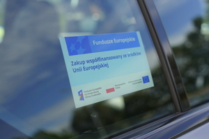 Zdjęcie przedstawia naklejkę "Zakup współfinansowany ze środków Unii Europejskiej" dla programu FEnIKS, która została umieszczona na bocznej szybie zakupionego samochodu BMW M340i xDrive.