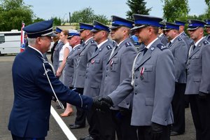 Komendant Wojewódzki Policji w Rzeszowie wręcza odznaczenie policjantowi.