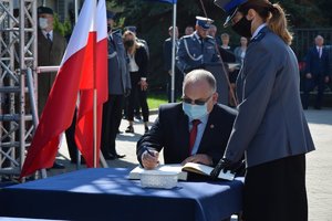 Uroczystość wręczenia sztandaru dla Komendy Powiatowej Policji w Ropczycach - zaproszeni goście wpisują się do księgi pamiątkowej