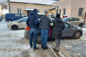 Policjanci prowadzą zatrzymanego